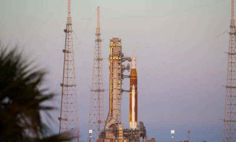 NASA's Artemis 1 rocket on launchpad with support structures and towers.