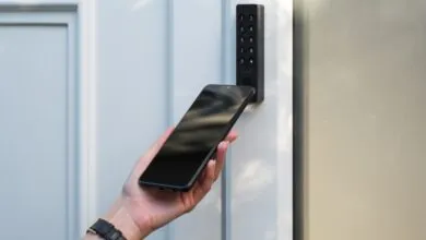 Person unlocks door with NFC keypad and smartphone.