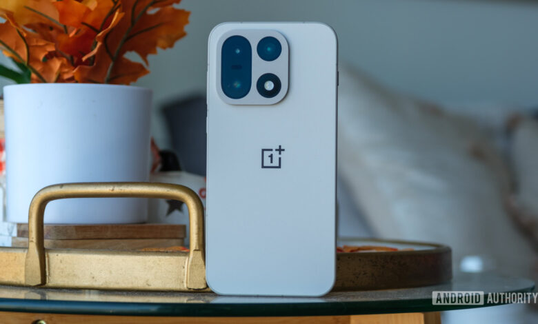 Close-up of a white OnePlus phone back, showcasing its camera module and logo.