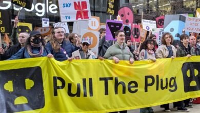 Protesters hold 'Pull The Plug' banner at Google AI protest.