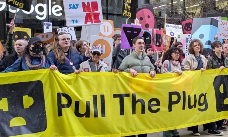 Protesters hold 'Pull The Plug' banner at Google AI protest.