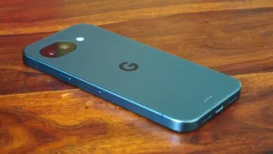 Back of blue Google Pixel phone with camera on wood surface
