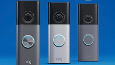 Three Ring video doorbells in different colors against a blue background.