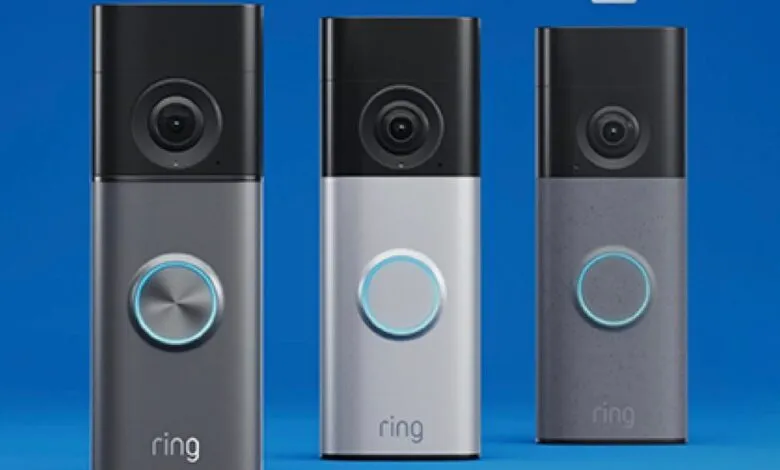 Three Ring video doorbells in different colors against a blue background.