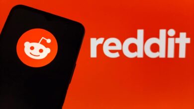 Reddit logo displayed on a smartphone screen against an orange background.