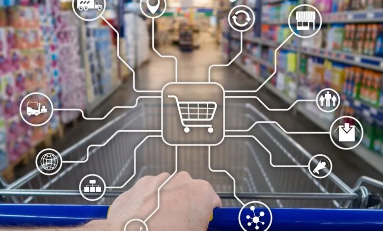 Hand pushing shopping cart with digital icons representing retail processes.