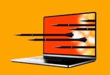 Laptop screen with missiles flying out, symbolizing cyber warfare.