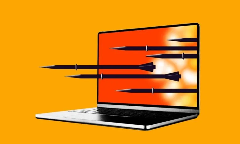 Laptop screen with missiles flying out, symbolizing cyber warfare.