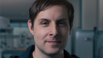 Headshot of a man with brown hair and a slight smile, looking directly at the camera.