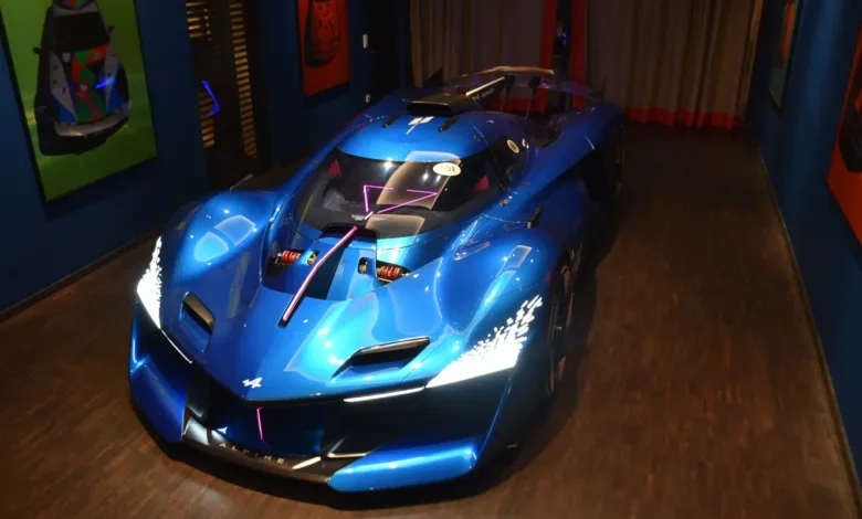 Stunning blue Alpine A290_β concept car on display in a modern showroom.