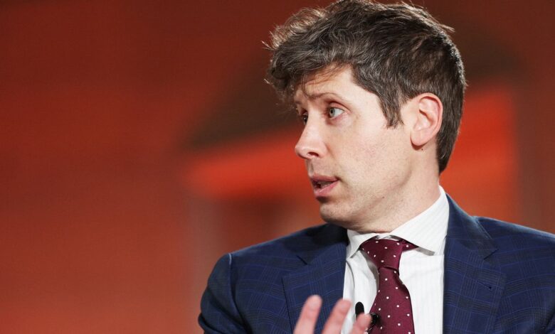 Man in suit speaking with animated expression, looking off-camera.