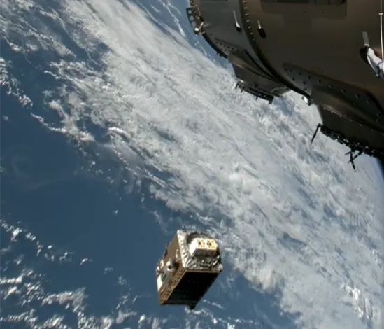 Satellite deploying from spacecraft with Earth visible in the background.