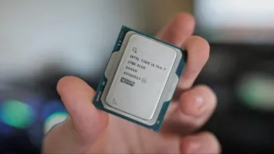 Hand holds Intel Core Ultra 7 270K Plus CPU, close-up view.
