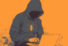 Person in hoodie with termite logo using laptop on orange background.