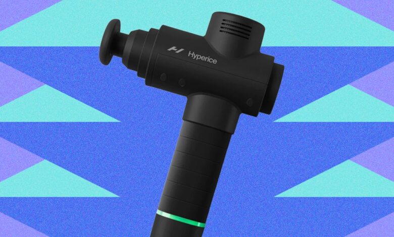 Black Hyperice massage gun against a blue and teal geometric background.
