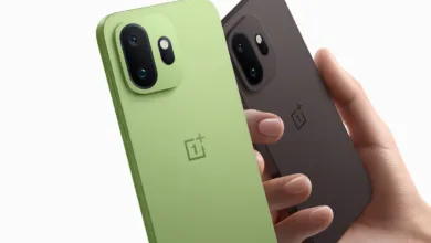 Two OnePlus phones, one green and one brown, held in a hand against a white background.