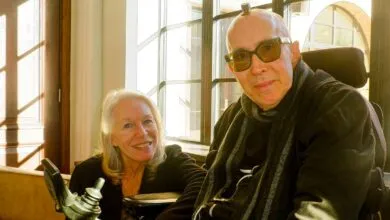 Galen and Deborah Buckwalter pose indoors by a window.