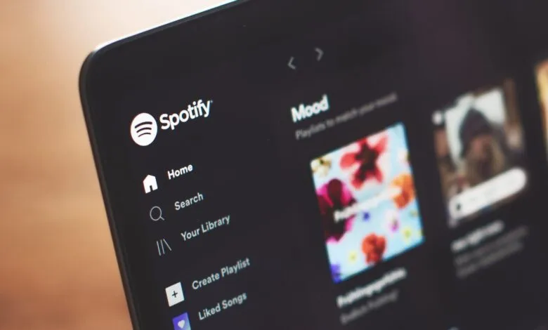 Spotify app interface on a tablet showing the home screen and mood playlists.