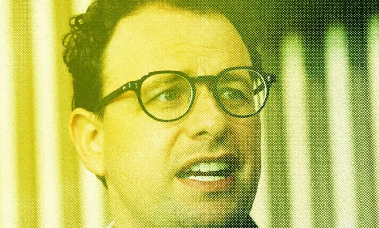 Close-up of a man with glasses, yellow and green halftone effect.
