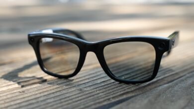 Close-up of black Ray-Ban Meta smart glasses on a wooden surface.