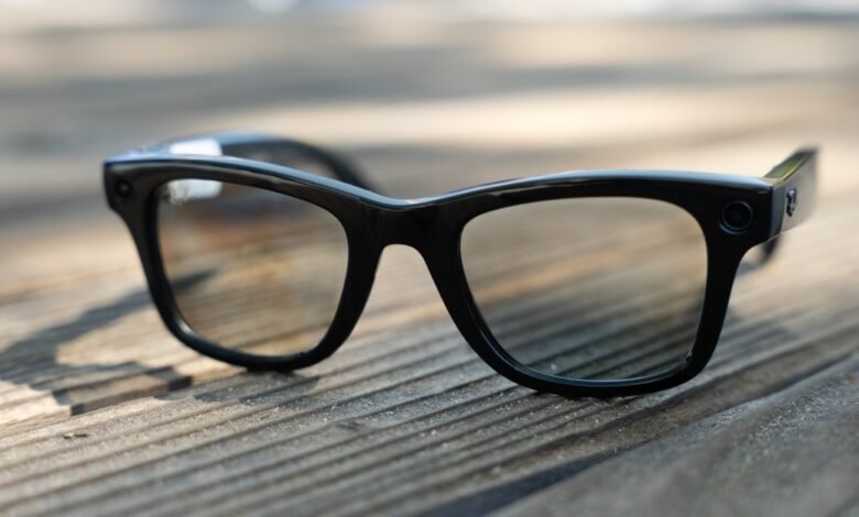 Close-up of black Ray-Ban Meta smart glasses on a wooden surface.
