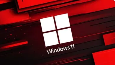 Windows 11 logo on a red and black abstract background.