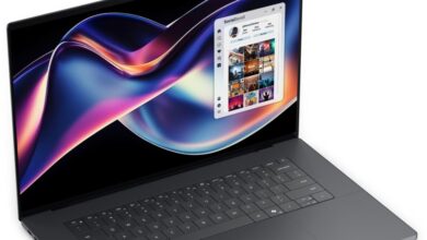 Laptop displaying a social media app with colorful abstract wallpaper.