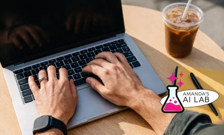 Hands typing on laptop with coffee, notebook, and pen on a wooden table.