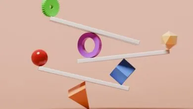 Abstract balance of colorful shapes on white levers against a peach background.