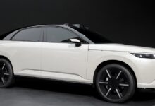 Sleek white Afeela electric vehicle with black roof and wheels.