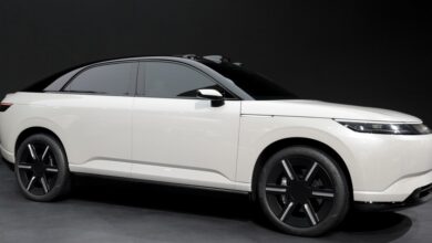 Sleek white Afeela electric vehicle with black roof and wheels.