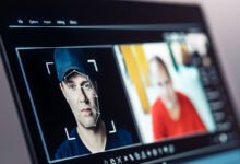 Laptop screen showing facial recognition software analyzing a man's face.