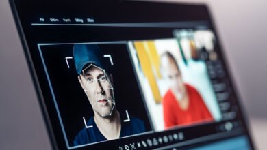 Laptop screen showing facial recognition software analyzing a man's face.