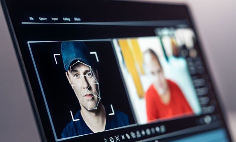 Laptop screen showing facial recognition software analyzing a man's face.
