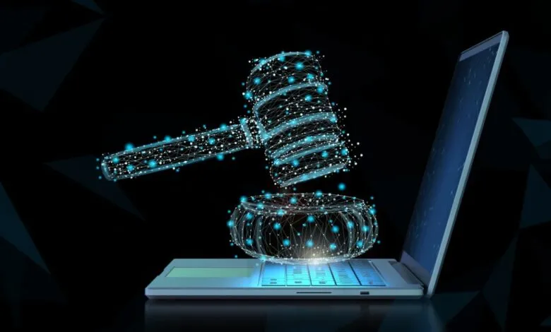 Digital gavel hovers over laptop, symbolizing online legal proceedings.