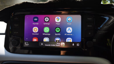 Car dashboard display showing Android Auto home screen with app icons.