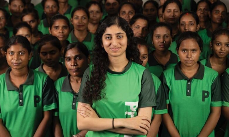 Group of women in green shirts, one with arms crossed in front.