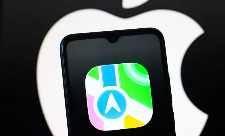 Apple Maps logo displayed on a smartphone screen against an Apple logo backdrop.