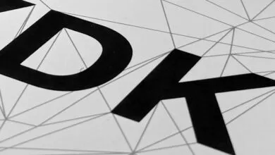 Close-up of 'XDK' in bold black letters against a geometric line pattern.