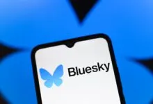 Bluesky app logo on a smartphone screen against a blue background.