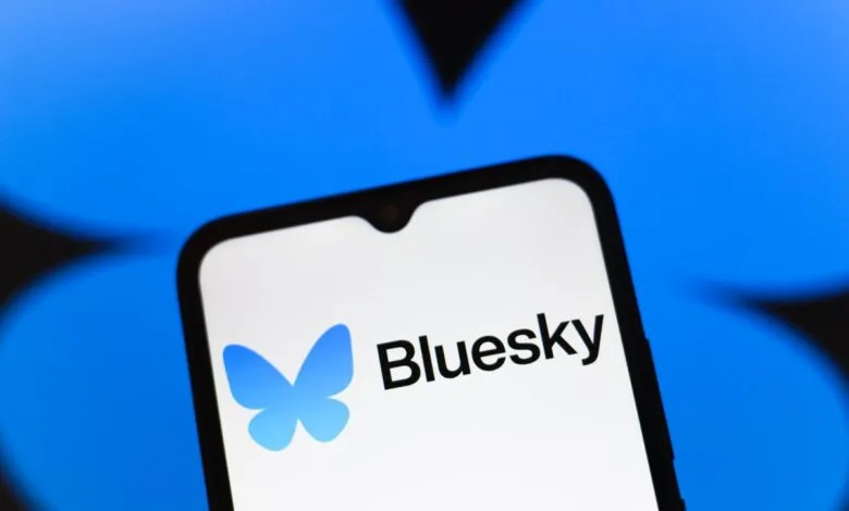 Bluesky app logo on a smartphone screen against a blue background.