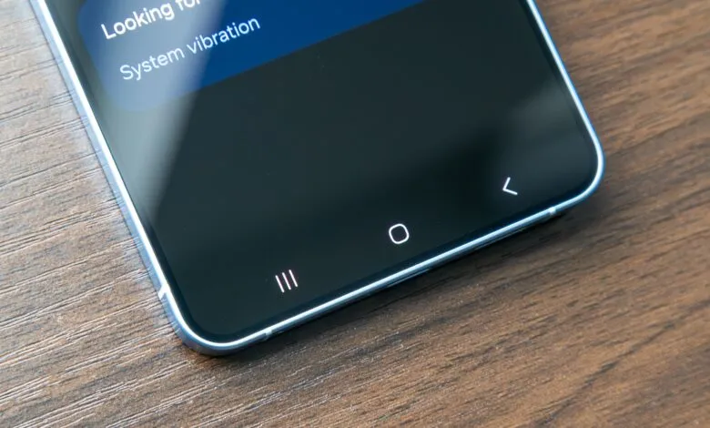 Close-up of smartphone screen showing navigation buttons and system settings.