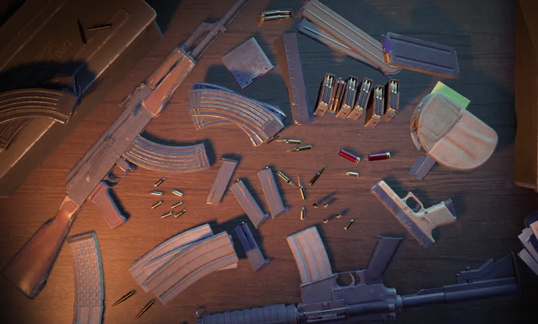 Overhead view of firearms, magazines, and ammunition scattered on a wooden surface.