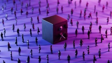 Safe surrounded by miniature figures on a purple surface.
