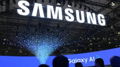 Large Samsung sign with falling confetti at a tech event.