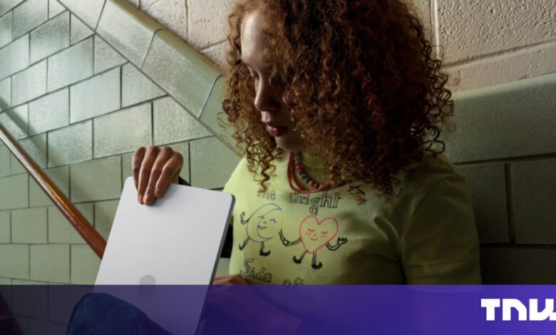 Person holding a tablet on a staircase with tiled walls.