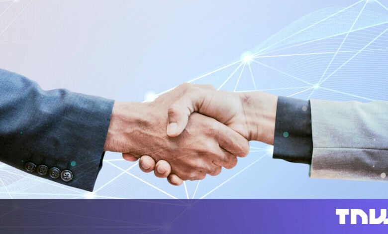 Two people in suits shaking hands against a light blue, networked background.