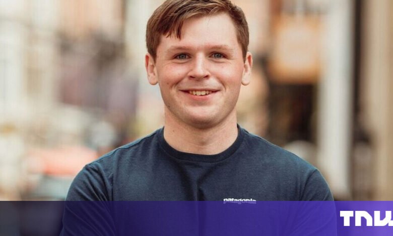 Portrait of a smiling man with short brown hair wearing a Patagonia t-shirt.