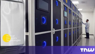 Scientist in lab coat working with advanced battery testing equipment.