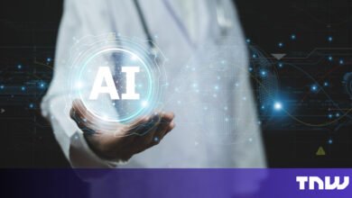 Hand holding AI symbol with digital globe and tech background.